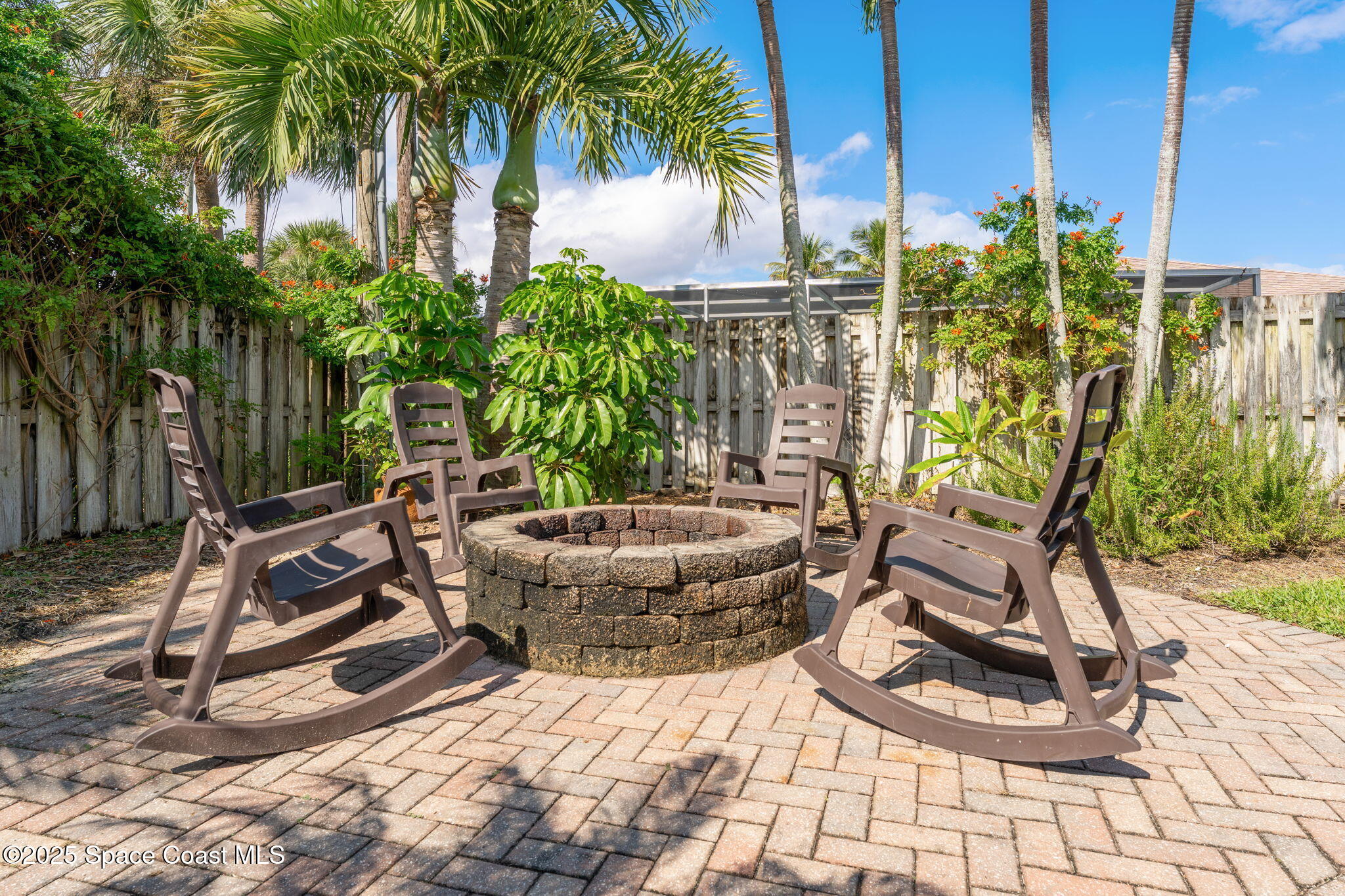 162 Miami Avenue Indialantic, FL 32903 - Photo 35 of 49 a view of a backyard with plants and palm tree
