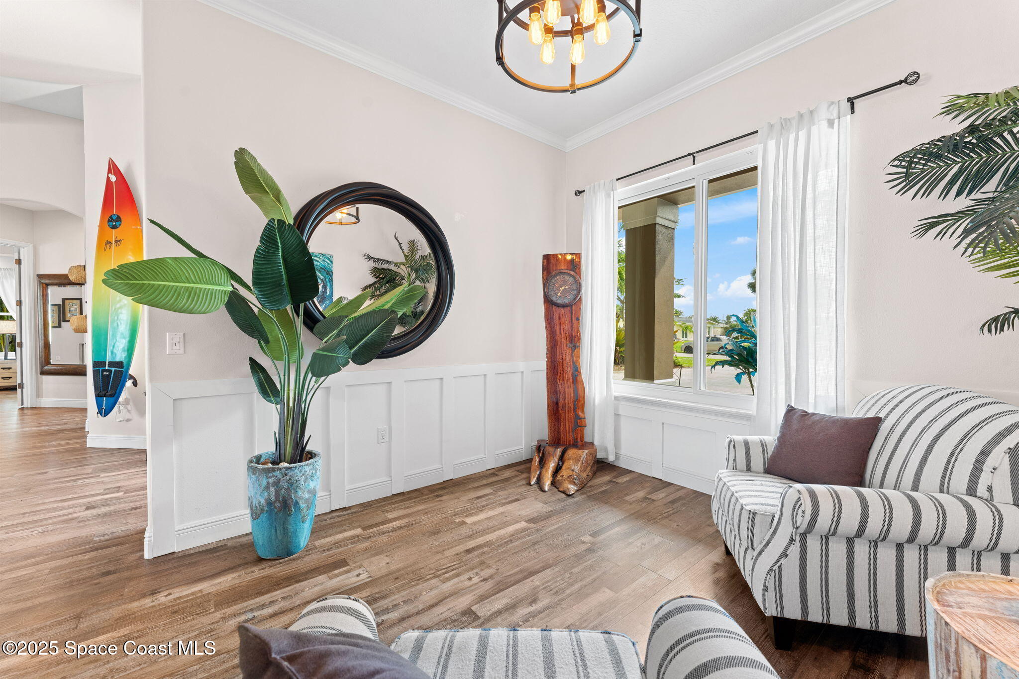 162 Miami Avenue Indialantic, FL 32903 - Photo 9 of 49 a bedroom with a bed and a chandelier