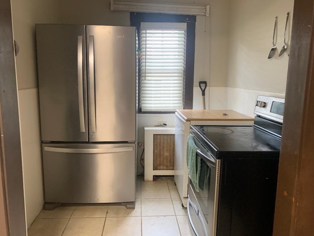 147 Belvidere Street Springfield, MA 01108 - Photo 12 of 27 a kitchen with stainless steel appliances granite countertop a refrigerator a sink and white cabinets