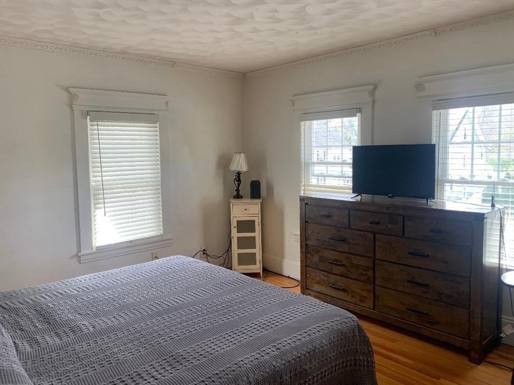 147 Belvidere Street Springfield, MA 01108 - Photo 18 of 27 a bedroom with a bed and a flat screen tv