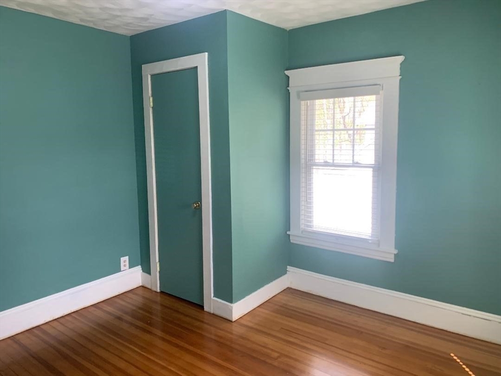 147 Belvidere Street Springfield, MA 01108 - Photo 22 of 27 an empty room with wooden floor closet and windows