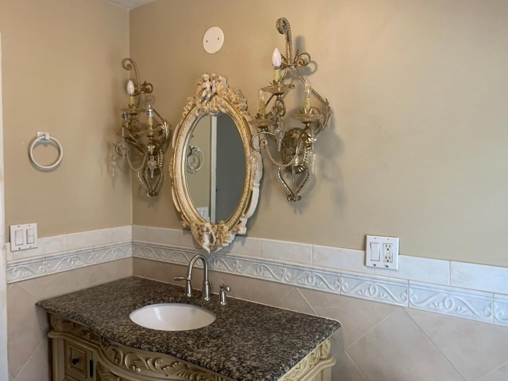 147 Belvidere Street Springfield, MA 01108 - Photo 23 of 27 a bathroom with a sink and a mirror