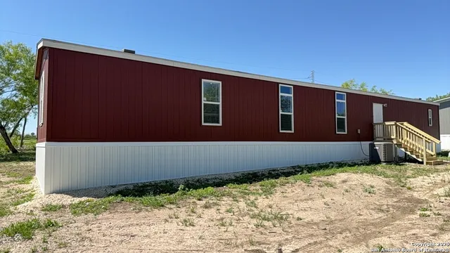 a backyard of a house with wooden fence