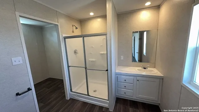 a bathroom with a double vanity sink and mirror