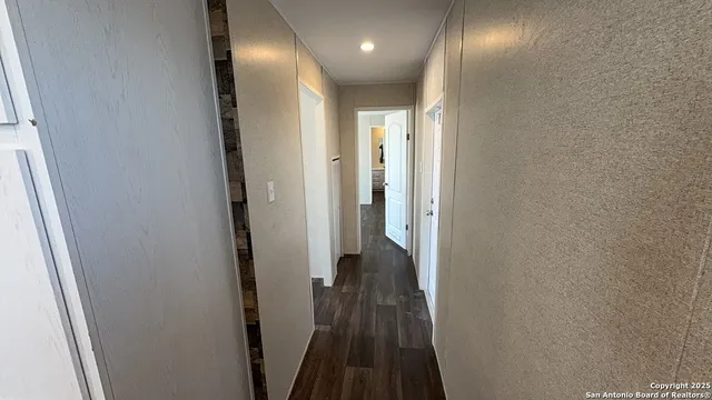 a view of hallway with wooden floor