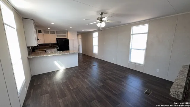 a view of a kitchen with wooden floor and a kitchen