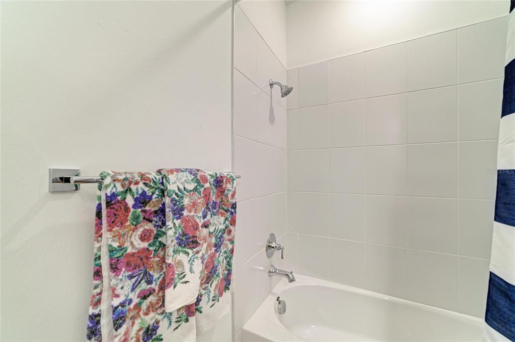 16341 Hidden Oak Loop Lakewood Ranch, FL 34211 - Photo 34 of 76 a bathroom with a bathtub and a shower