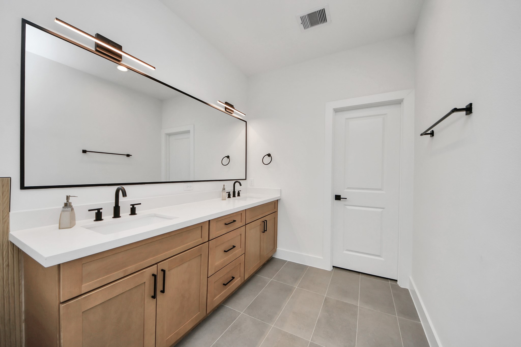 505 Middle Street Houston, TX 77003 - Photo 28 of 46 This modern bathroom offers sleek double sinks set against a spacious vanity, perfect for a stylish and functional start to your day.