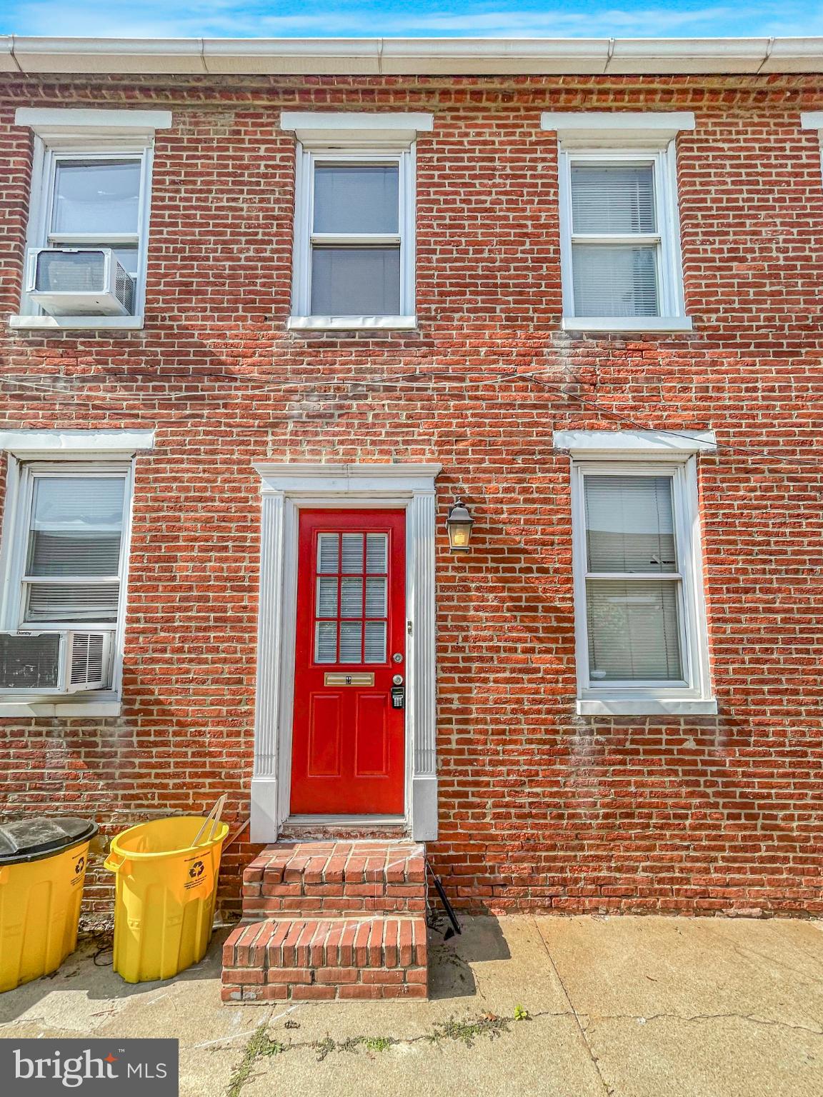 1436 Light Street Baltimore, MD 21230 - Photo 15 of 21 Charming brick facade with a vibrant red door.