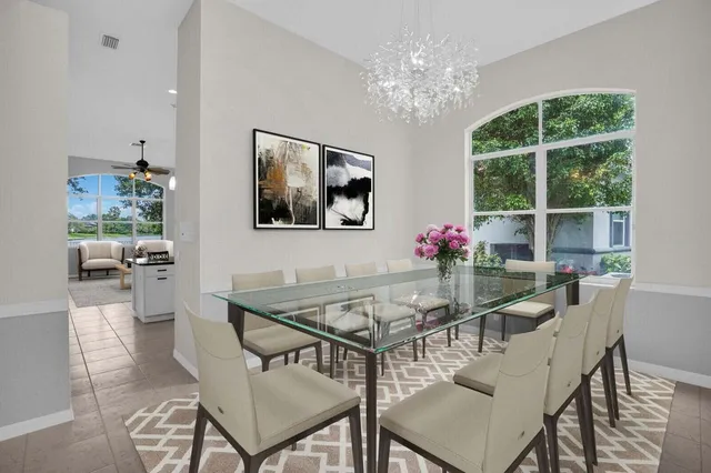 a view of a dining room with furniture and chandelier