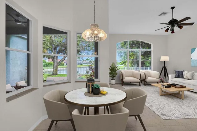 a living room with furniture a table and a large window