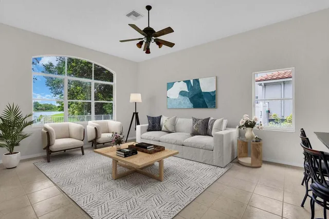 a living room with furniture and kitchen view