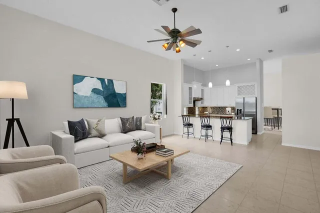 a living room with furniture and kitchen view