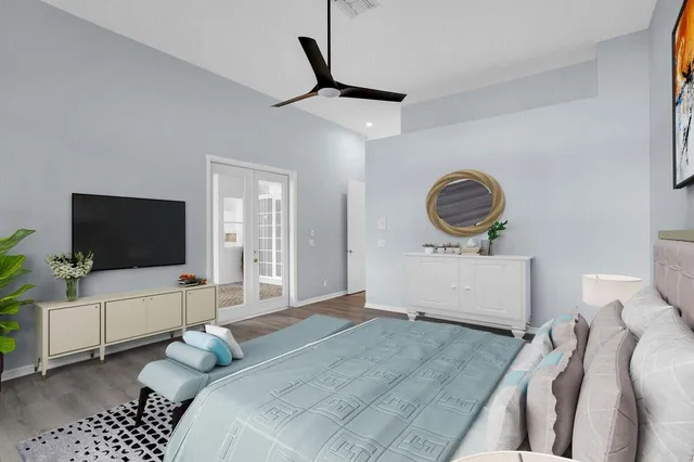 a bedroom with a bed a flat screen tv and a couch