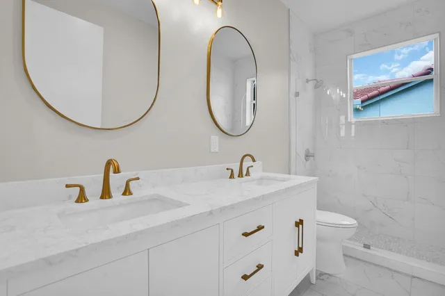 a bathroom with a toilet sink and mirror