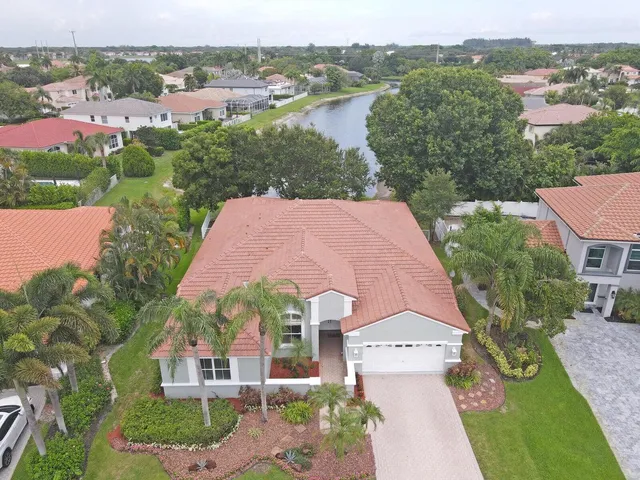 an aerial view of house with yard and ocean view