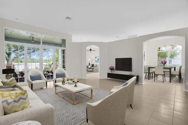 a dining room with furniture potted plants and wooden floor