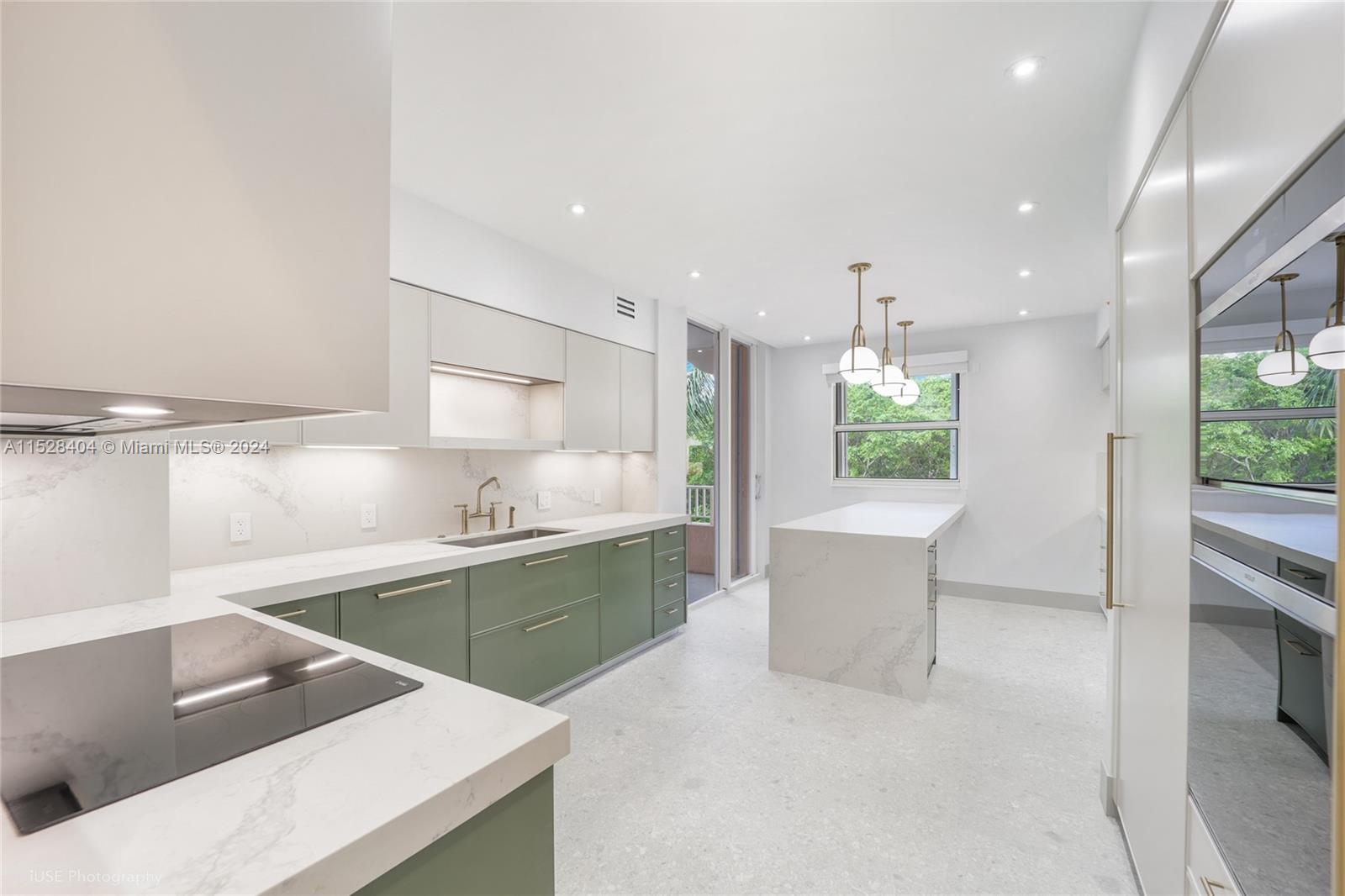 a kitchen with a refrigerator and a sink