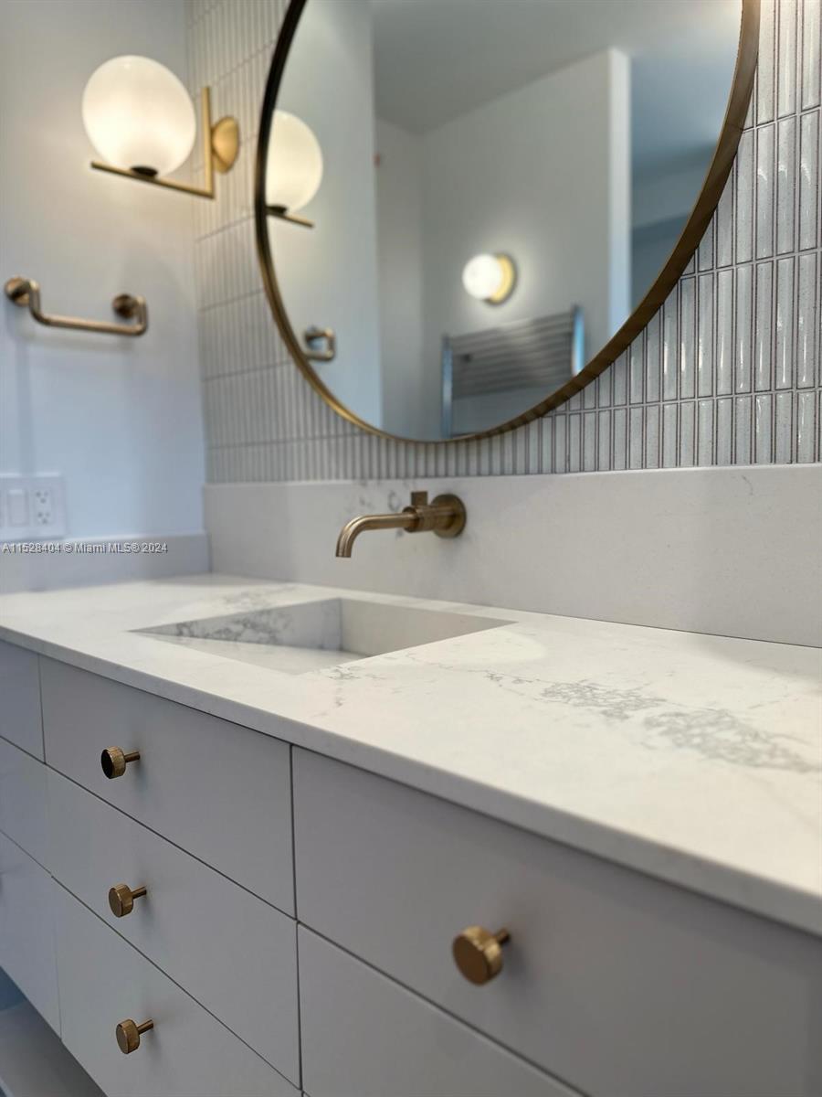 Lake Villa Key Biscayne, FL 33149 - Photo 20 of 51 a bathroom with a sink and a mirror