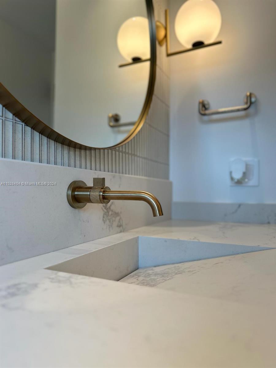 Lake Villa Key Biscayne, FL 33149 - Photo 21 of 51 a bathroom with a tub a mirror and vanity