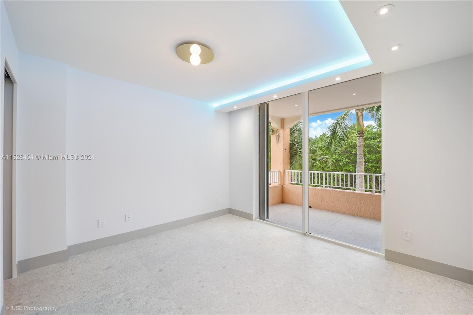 Lake Villa Key Biscayne, FL 33149 - Photo 26 of 51 a view of an empty room with wooden floor and a window