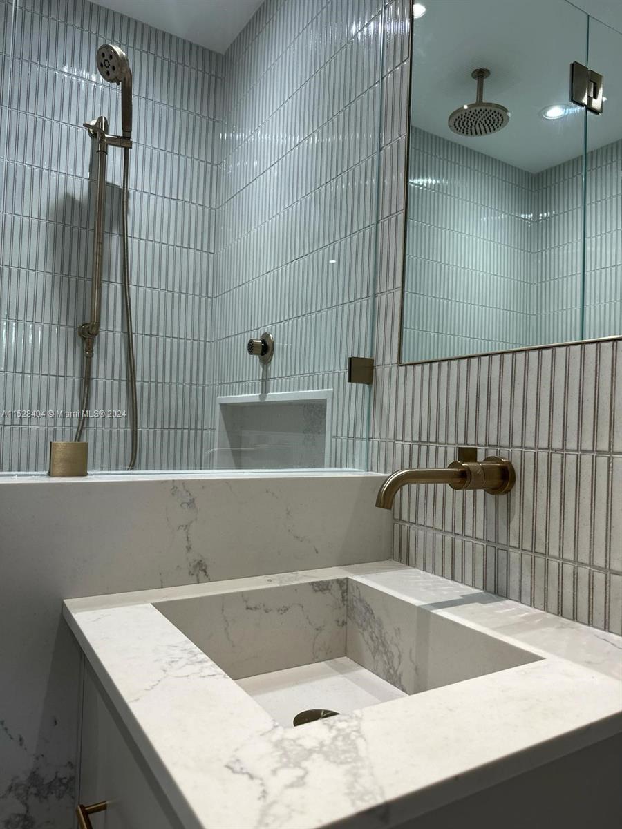 Lake Villa Key Biscayne, FL 33149 - Photo 29 of 51 a bathroom with a bathtub and sink