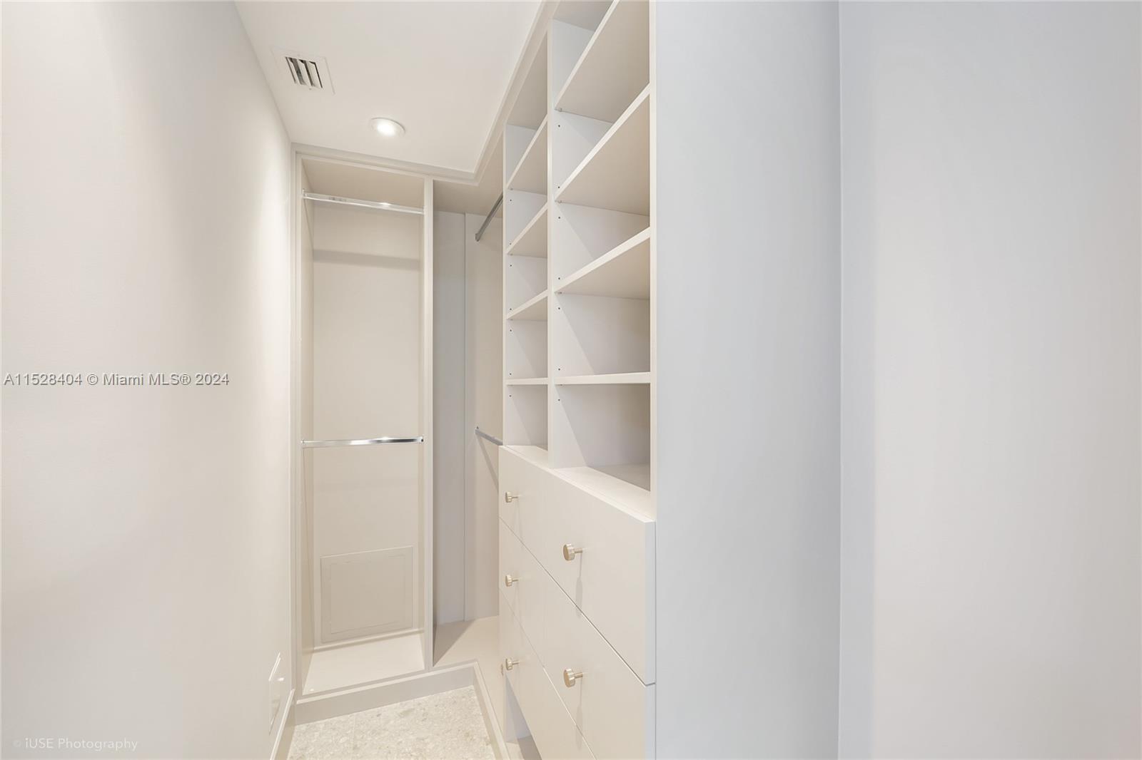 Lake Villa Key Biscayne, FL 33149 - Photo 30 of 51 a view of an empty walk in closet