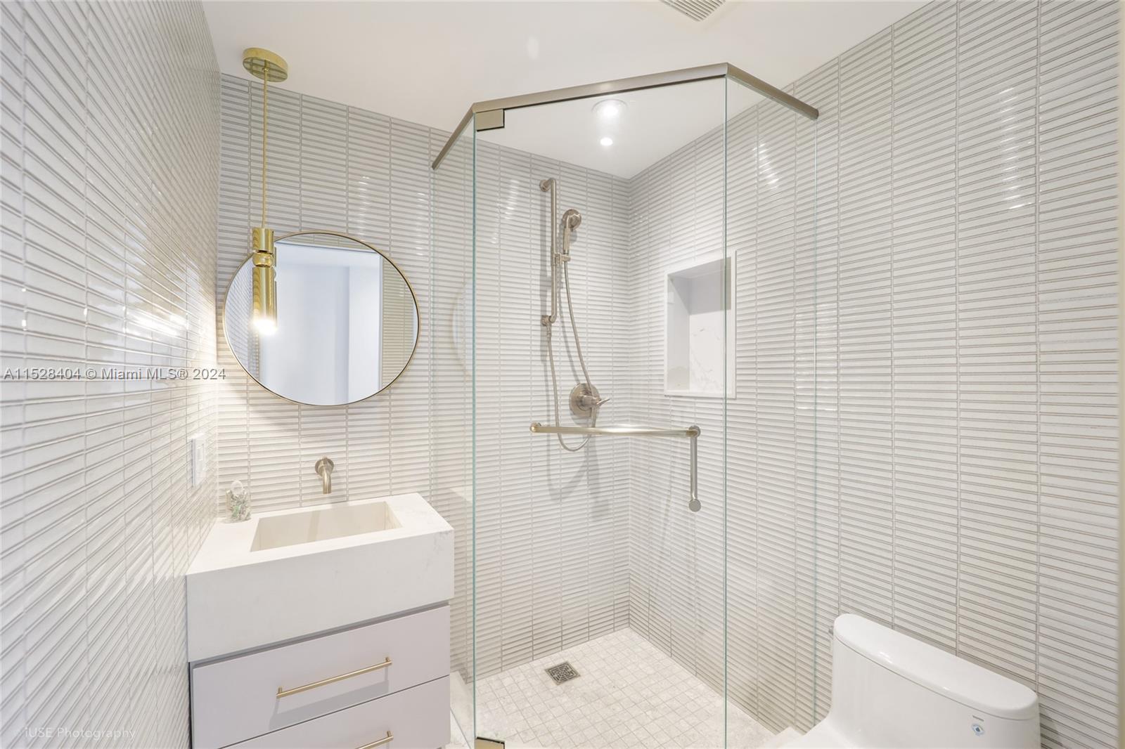 Lake Villa Key Biscayne, FL 33149 - Photo 31 of 51 a bathroom with a sink a toilet and shower