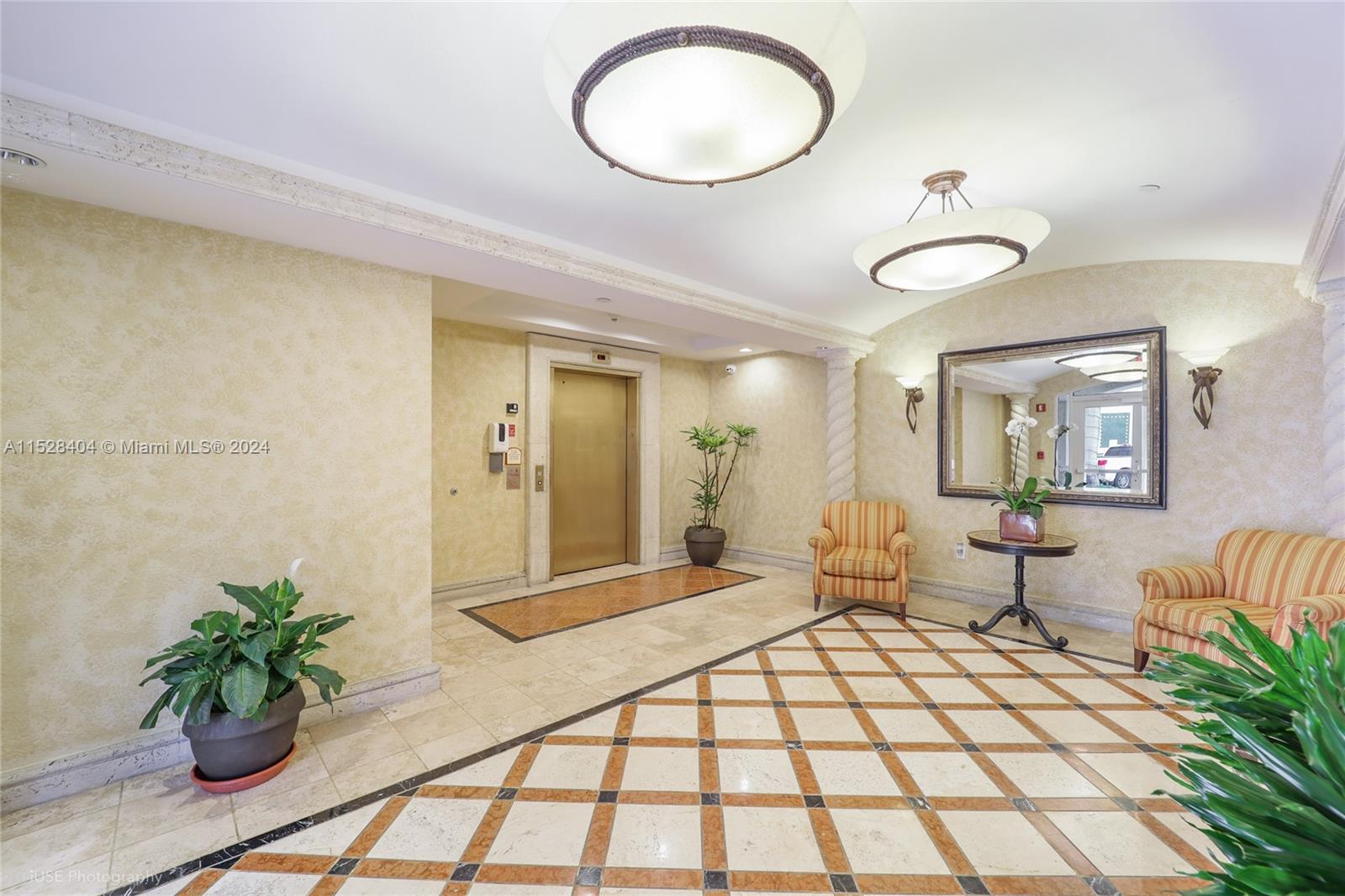 Lake Villa Key Biscayne, FL 33149 - Photo 34 of 51 a bedroom with a large bed and chandelier