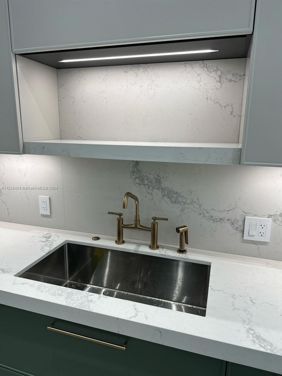 Lake Villa Key Biscayne, FL 33149 - Photo 4 of 51 a kitchen with a sink and a refrigerator