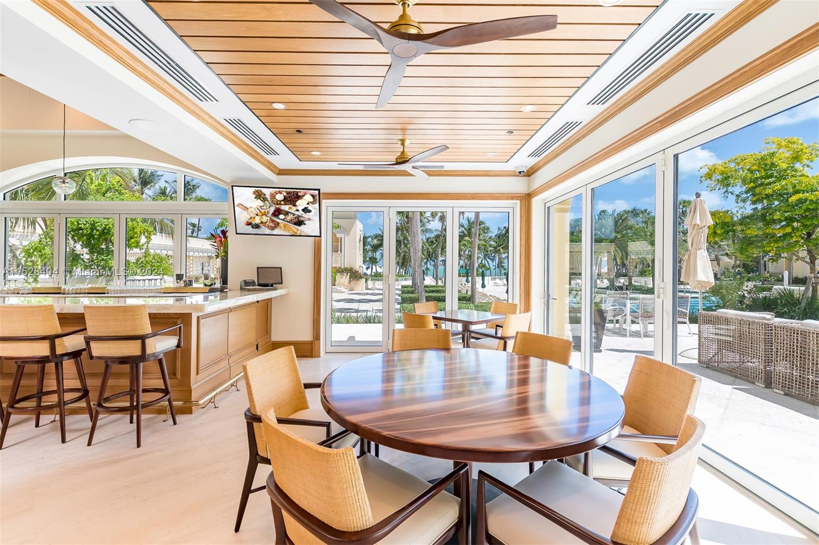 Lake Villa Key Biscayne, FL 33149 - Photo 41 of 51 a dining room with furniture a chandelier and wooden floor