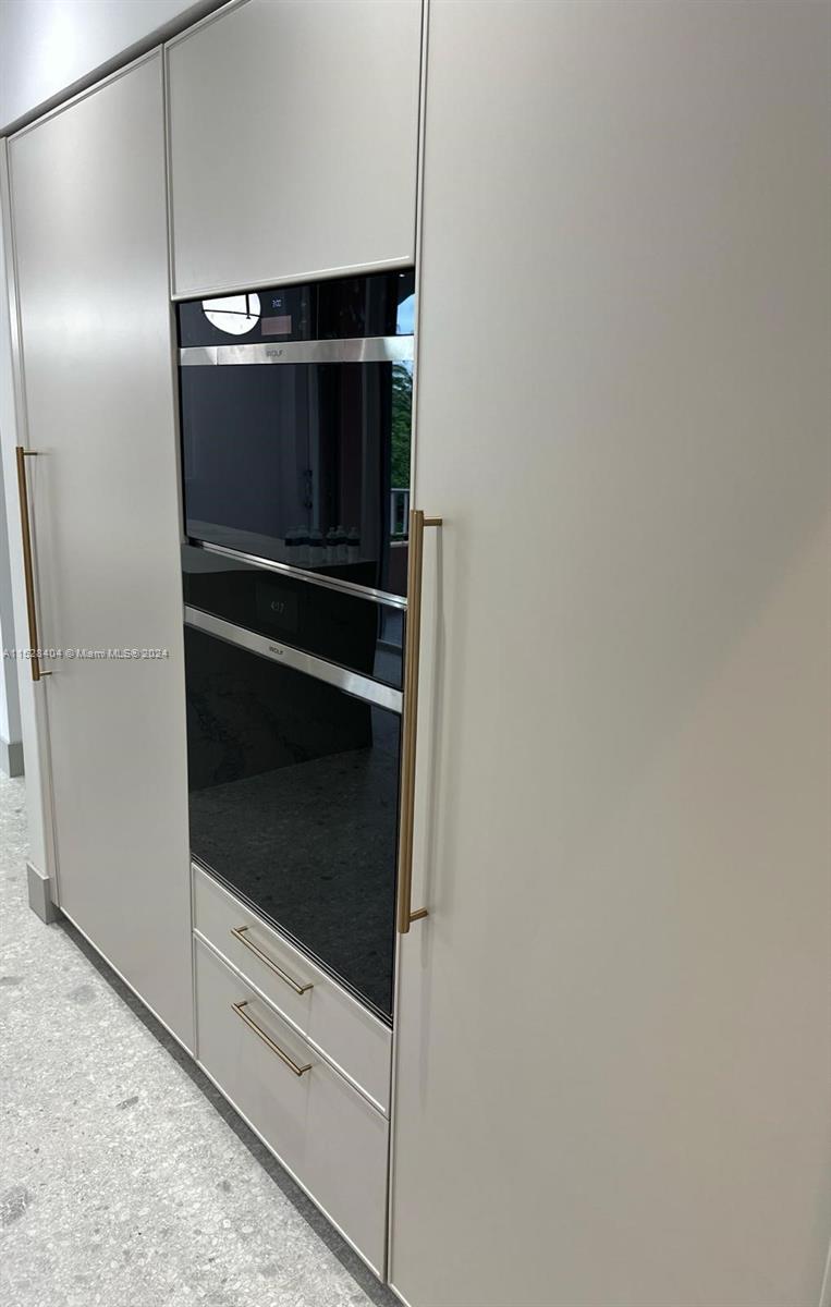 Lake Villa Key Biscayne, FL 33149 - Photo 6 of 51 a metallic refrigerator freezer sitting in a kitchen