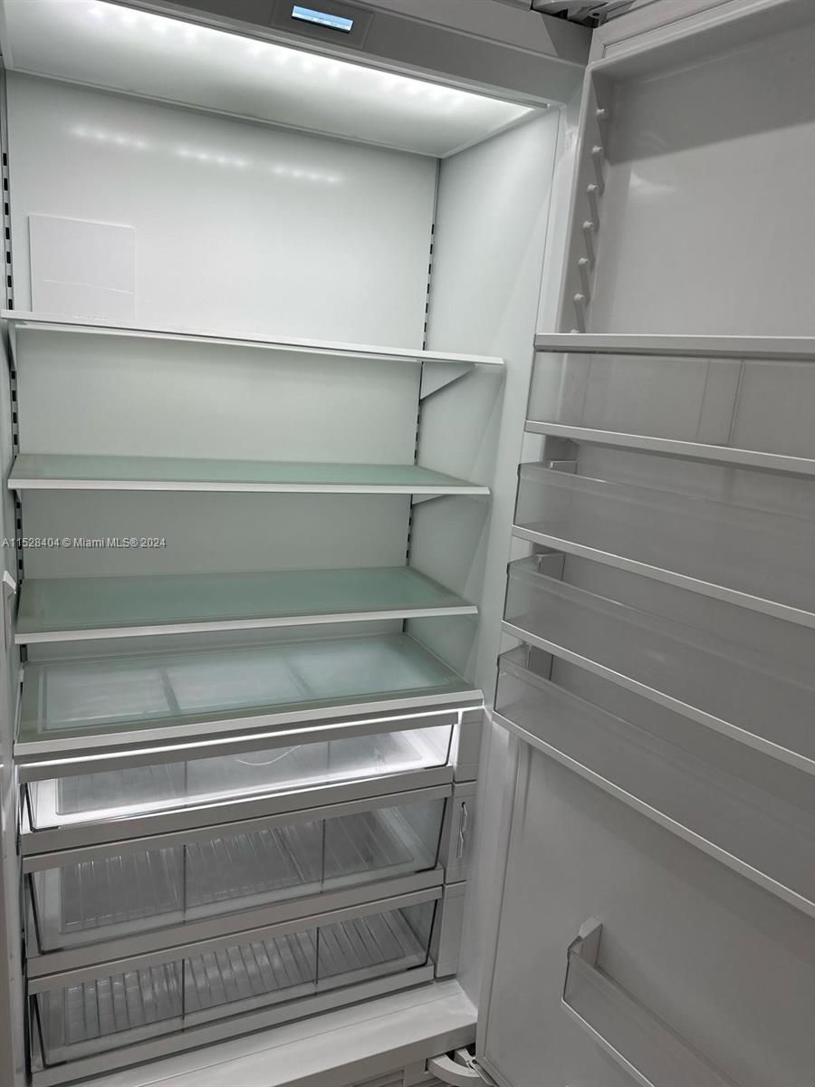 Lake Villa Key Biscayne, FL 33149 - Photo 8 of 51 a view of walk in closet with empty racks