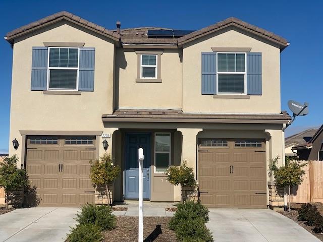2205 Lombard Lane Clovis, CA 93619 - Photo 1 of 13 a front view of a house with a yard
