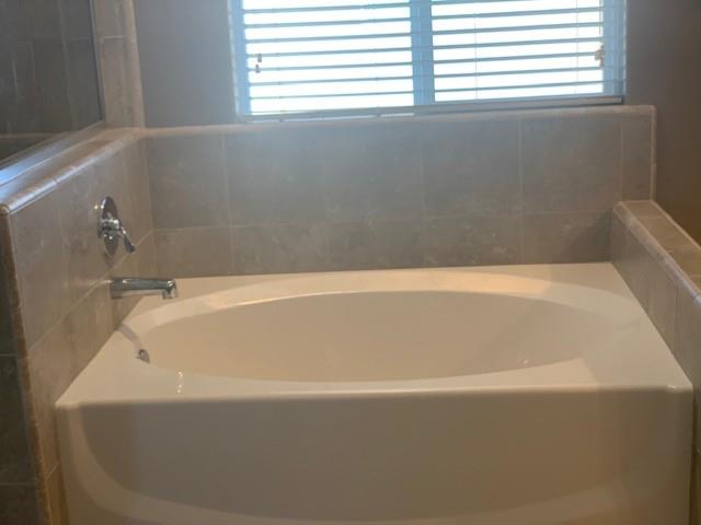 2205 Lombard Lane Clovis, CA 93619 - Photo 8 of 13 a bathroom with a bathtub
