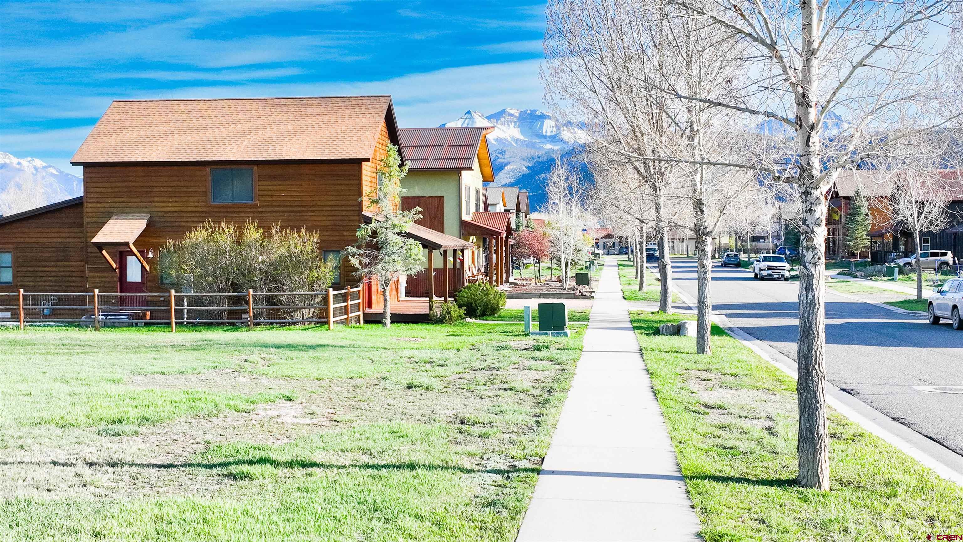 470-480 Kismet Street Ridgway, CO 81432 - Photo 19 of 20 a front view of a house with a yard