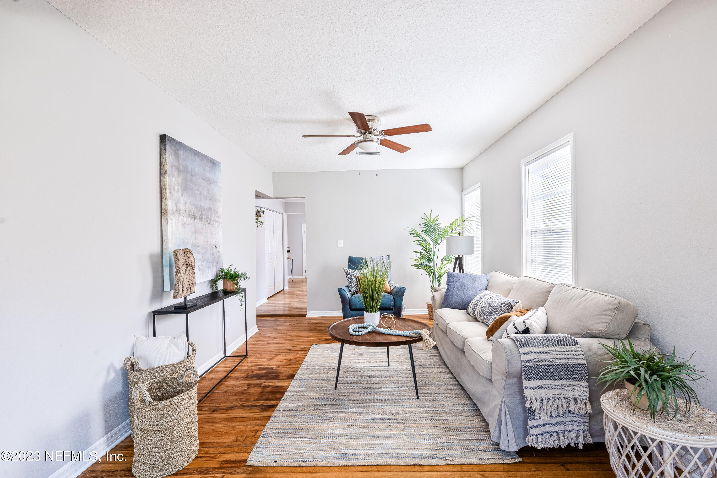 4729 Cambridge Road Jacksonville, FL 32210 - Photo 12 of 37 a living room with furniture and wooden floor