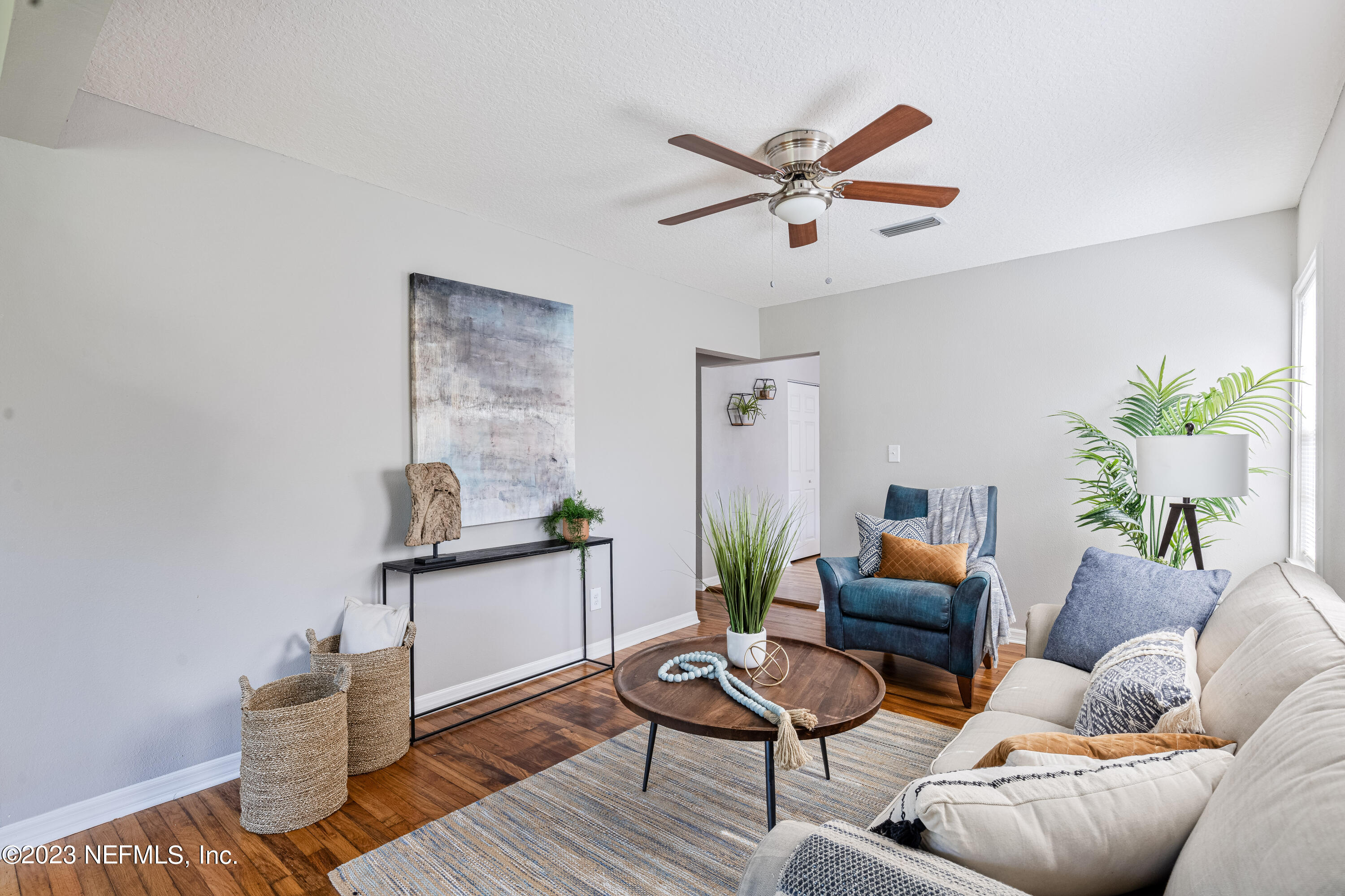 4729 Cambridge Road Jacksonville, FL 32210 - Photo 13 of 37 a living room with furniture and wooden floor