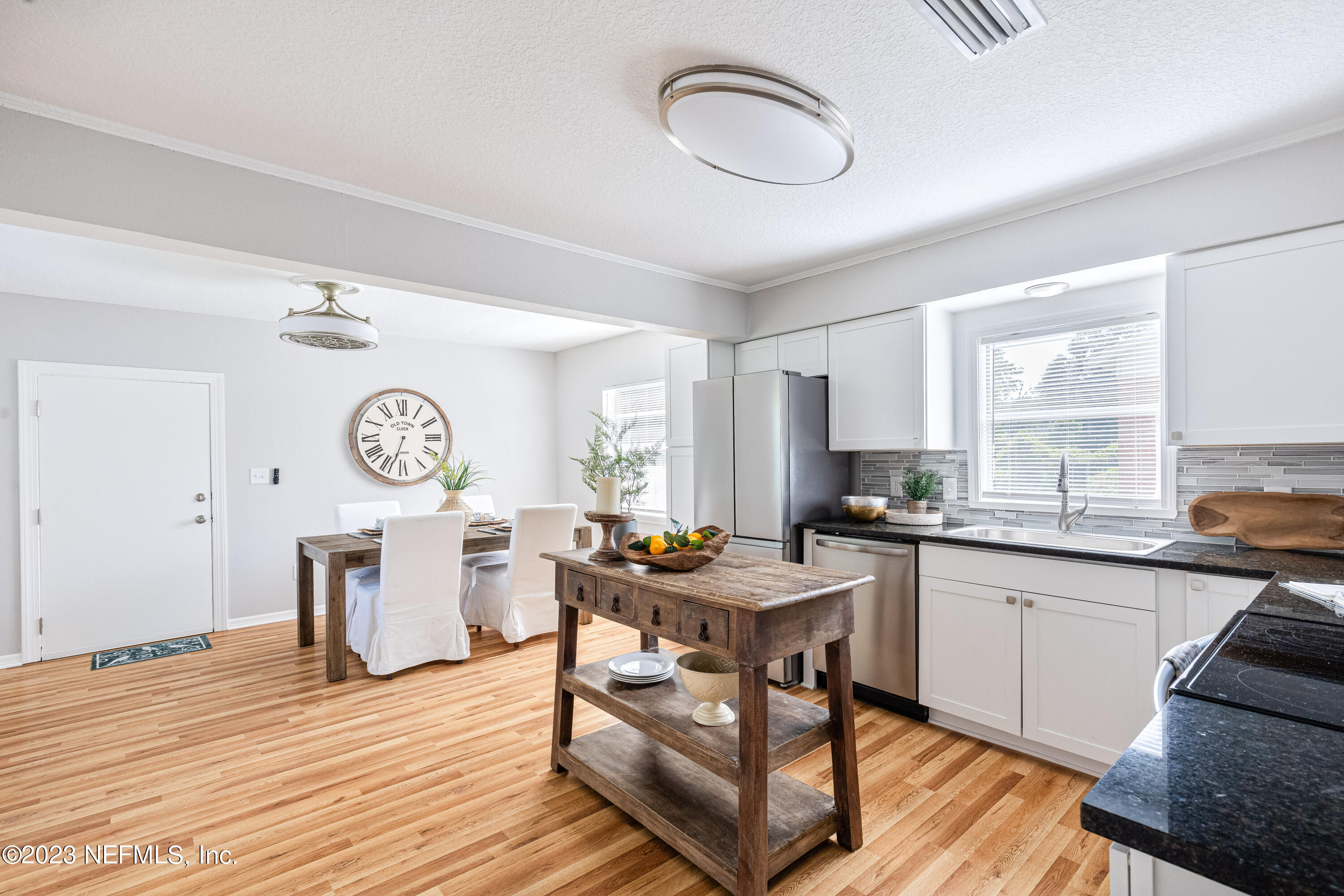 4729 Cambridge Road Jacksonville, FL 32210 - Photo 17 of 37 a view of a kitchen area with furniture and wooden floor