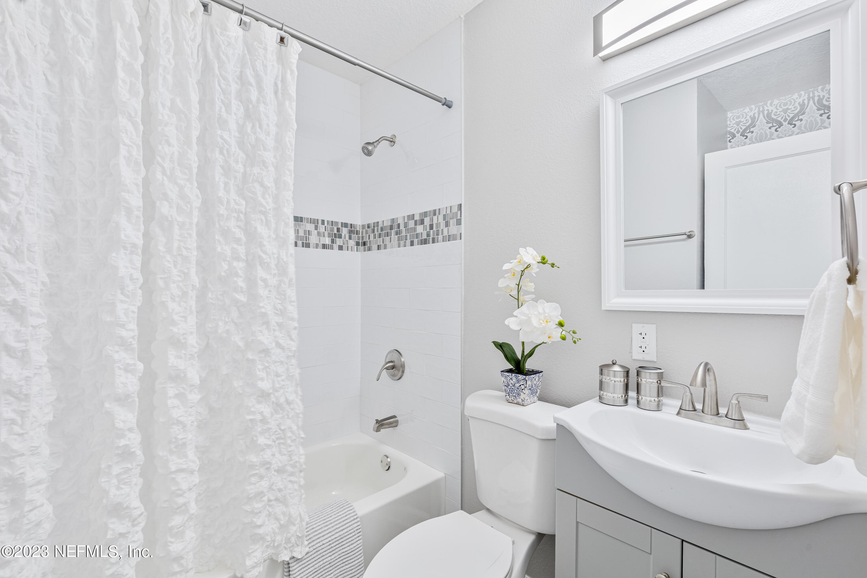 4729 Cambridge Road Jacksonville, FL 32210 - Photo 25 of 37 a bathroom with a sink a toilet and a mirror