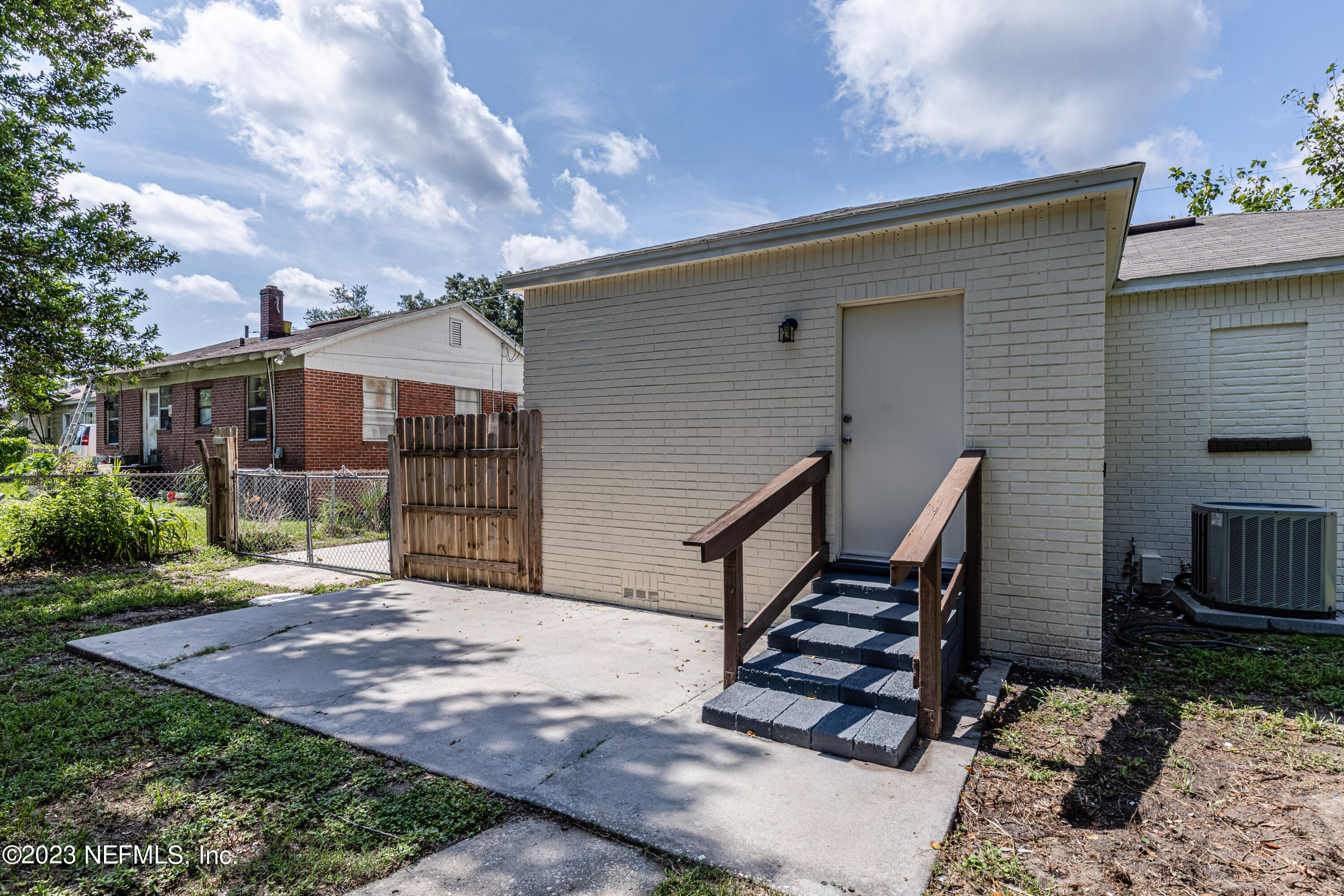4729 Cambridge Road Jacksonville, FL 32210 - Photo 34 of 37 a view of a house with wooden deck and furniture