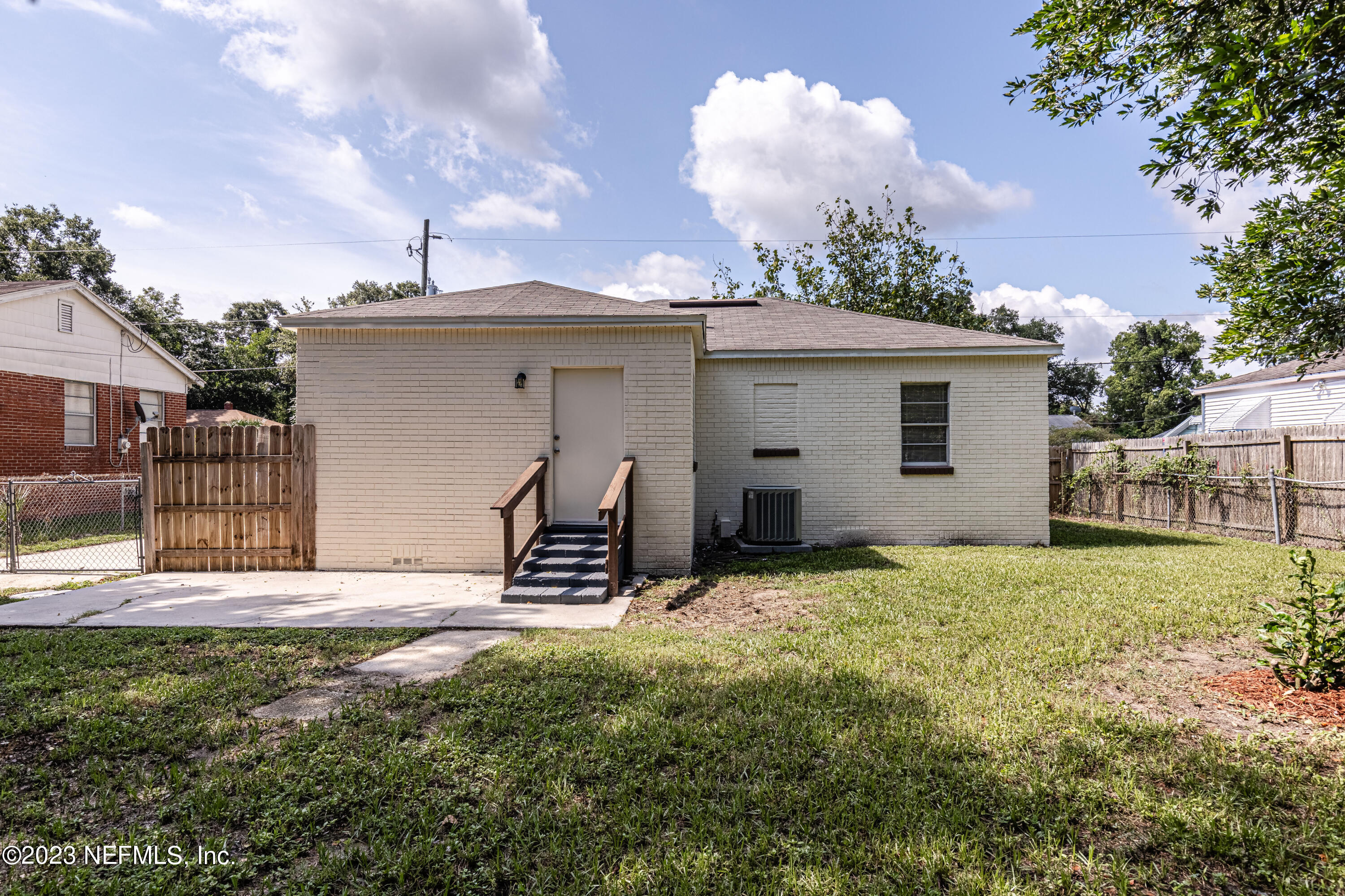 4729 Cambridge Road Jacksonville, FL 32210 - Photo 37 of 37 a view of a house with backyard and a tree