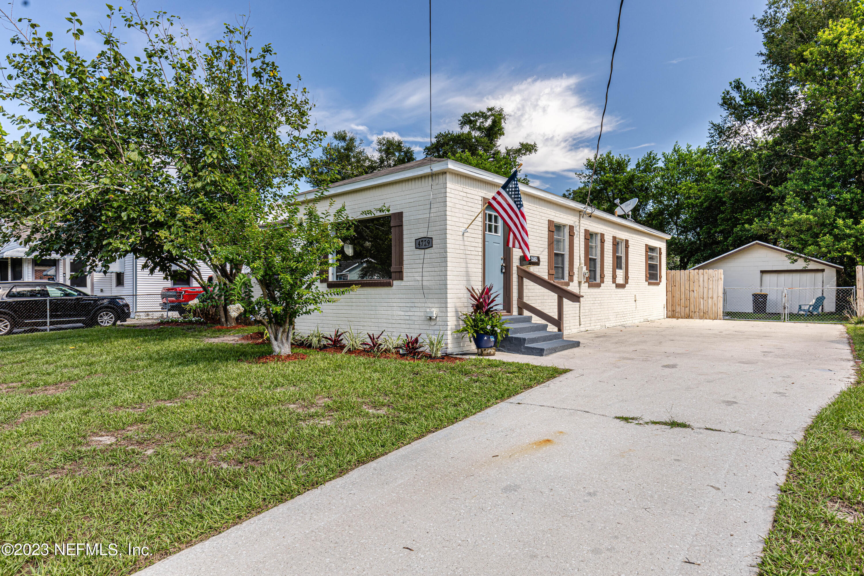 4729 Cambridge Road Jacksonville, FL 32210 - Photo 4 of 37 a front view of house with small garden and tree