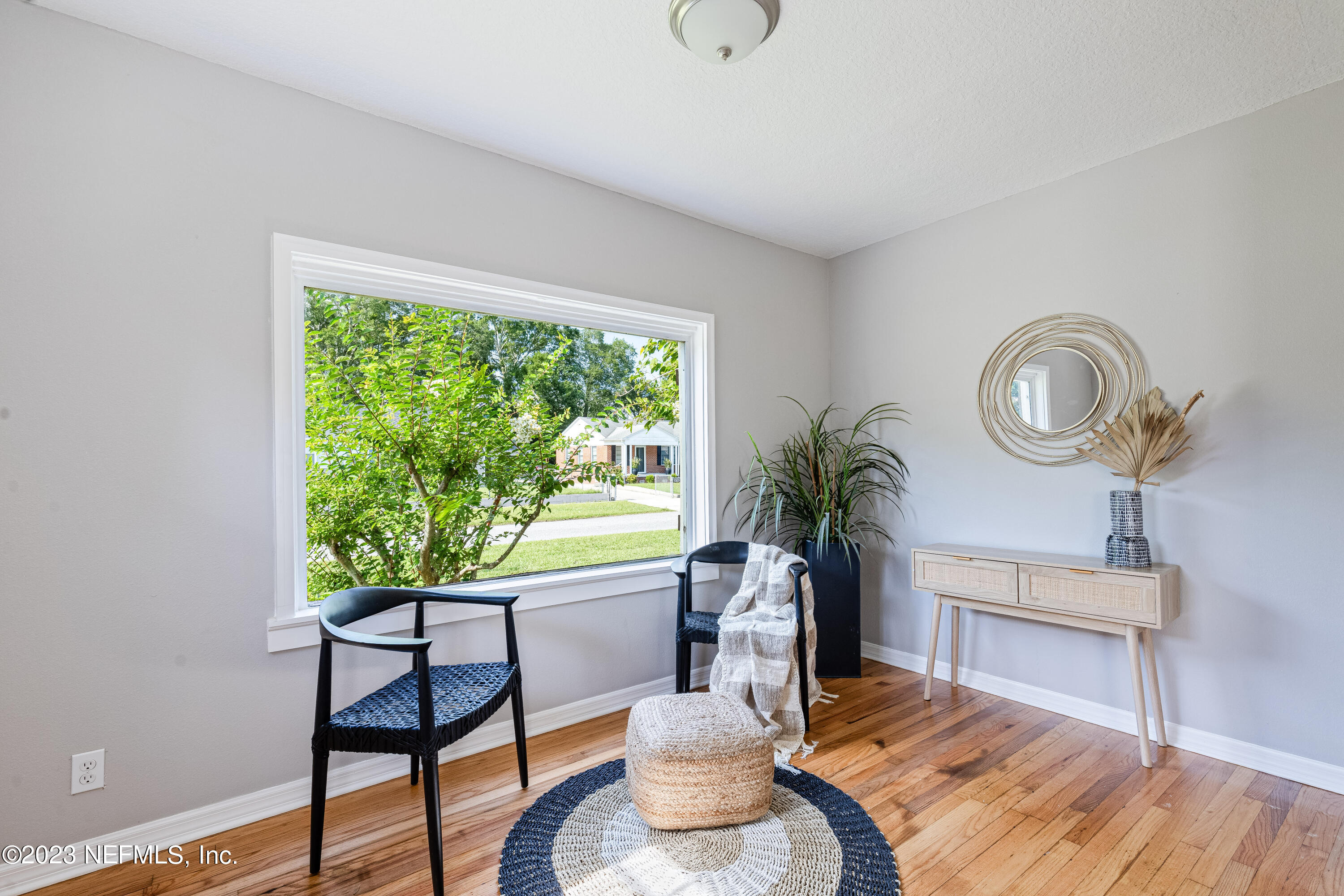 4729 Cambridge Road Jacksonville, FL 32210 - Photo 9 of 37 a living room with furniture a window and a potted plant