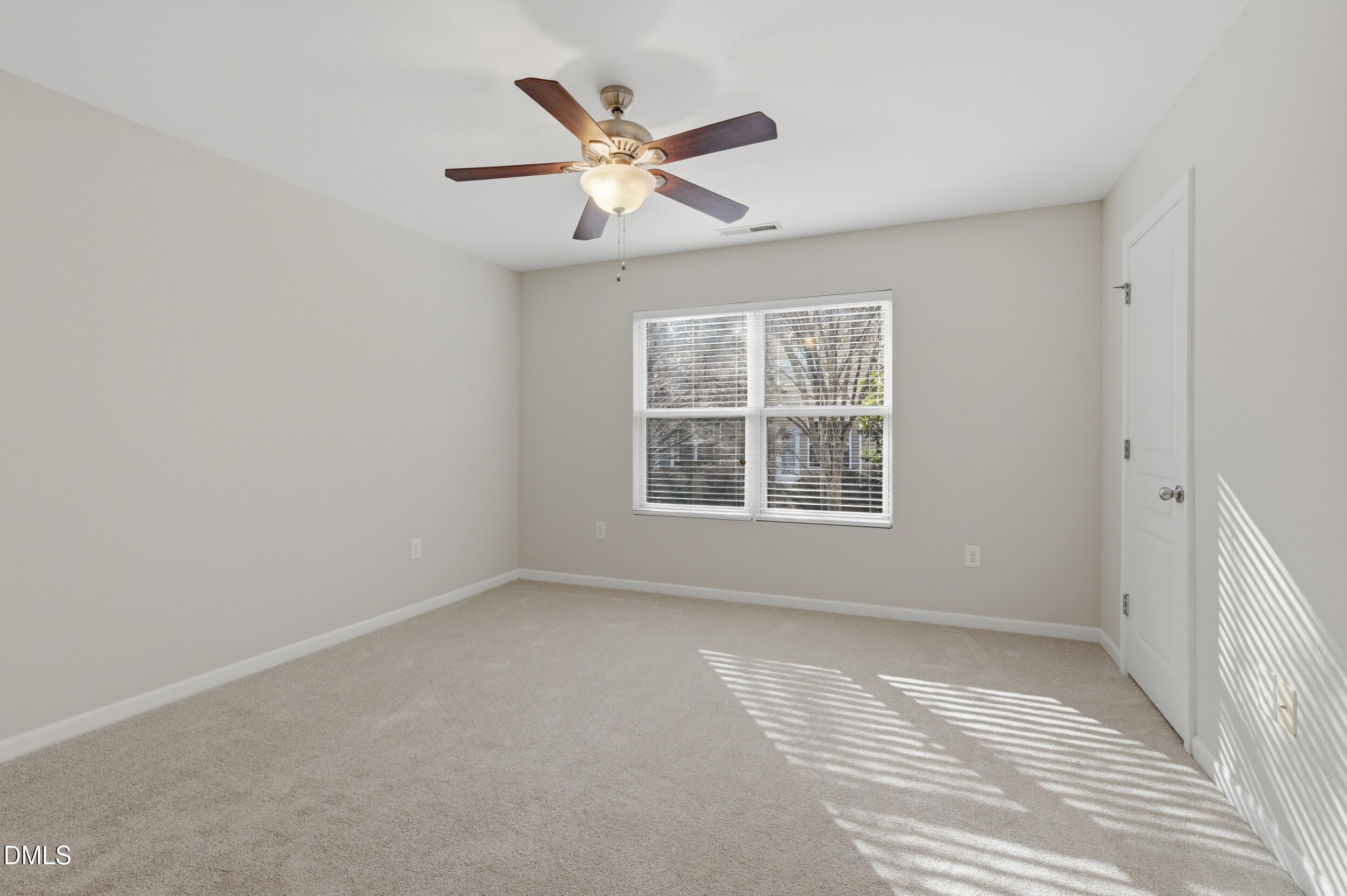 2907 Berkeley Springs Place Raleigh, NC 27616 - Photo 15 of 32 an empty room with window and ceiling fan