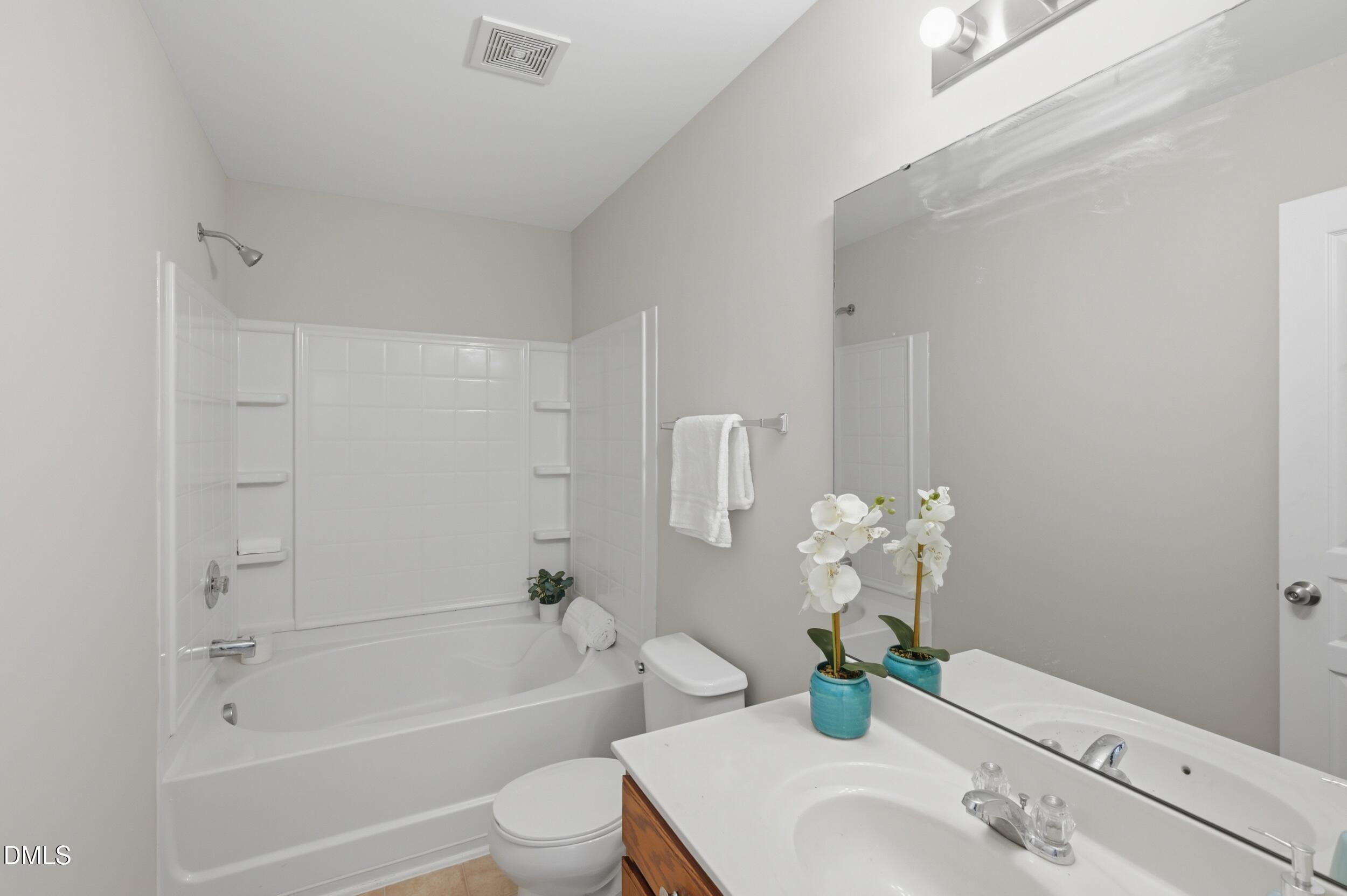 2907 Berkeley Springs Place Raleigh, NC 27616 - Photo 16 of 32 a bathroom with a sink a toilet and bathtub