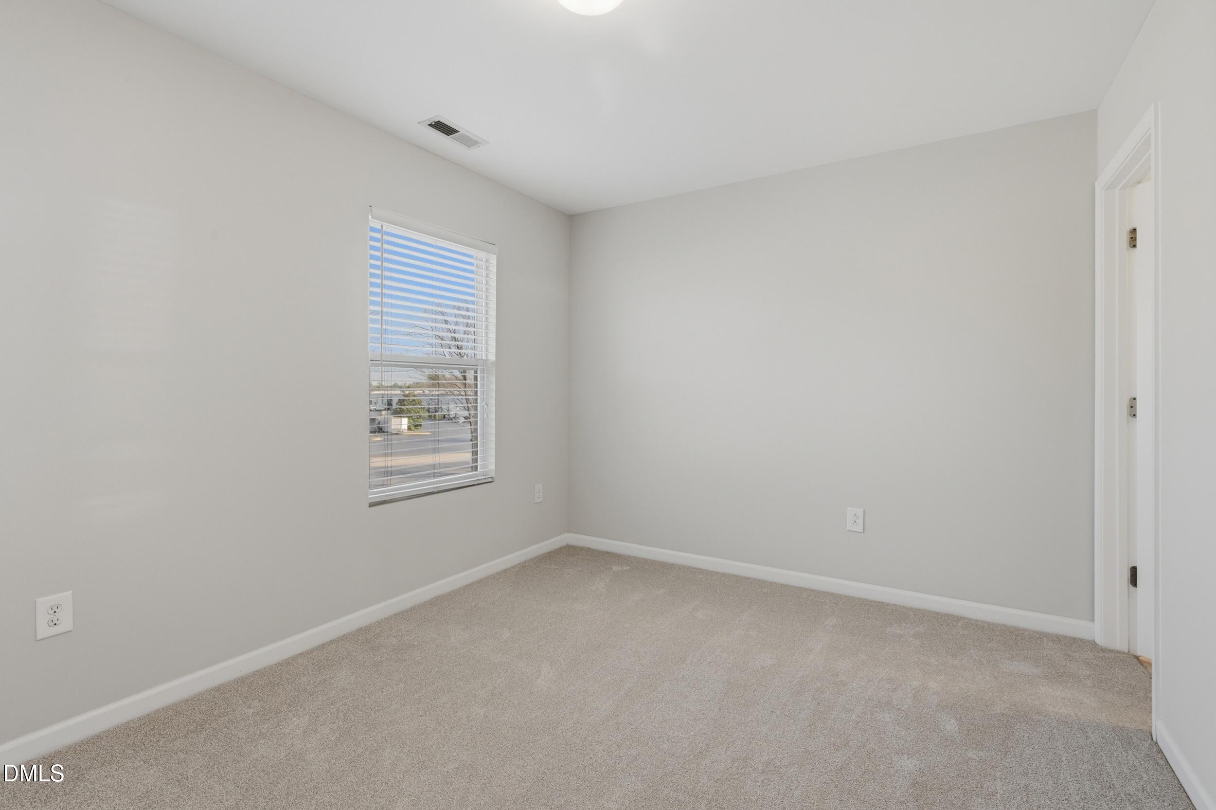 2907 Berkeley Springs Place Raleigh, NC 27616 - Photo 18 of 32 an empty room with a window