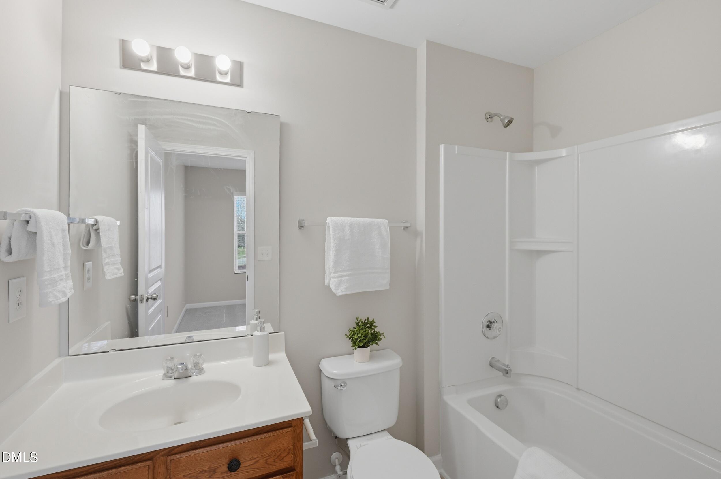2907 Berkeley Springs Place Raleigh, NC 27616 - Photo 19 of 32 a bathroom with a sink toilet and shower
