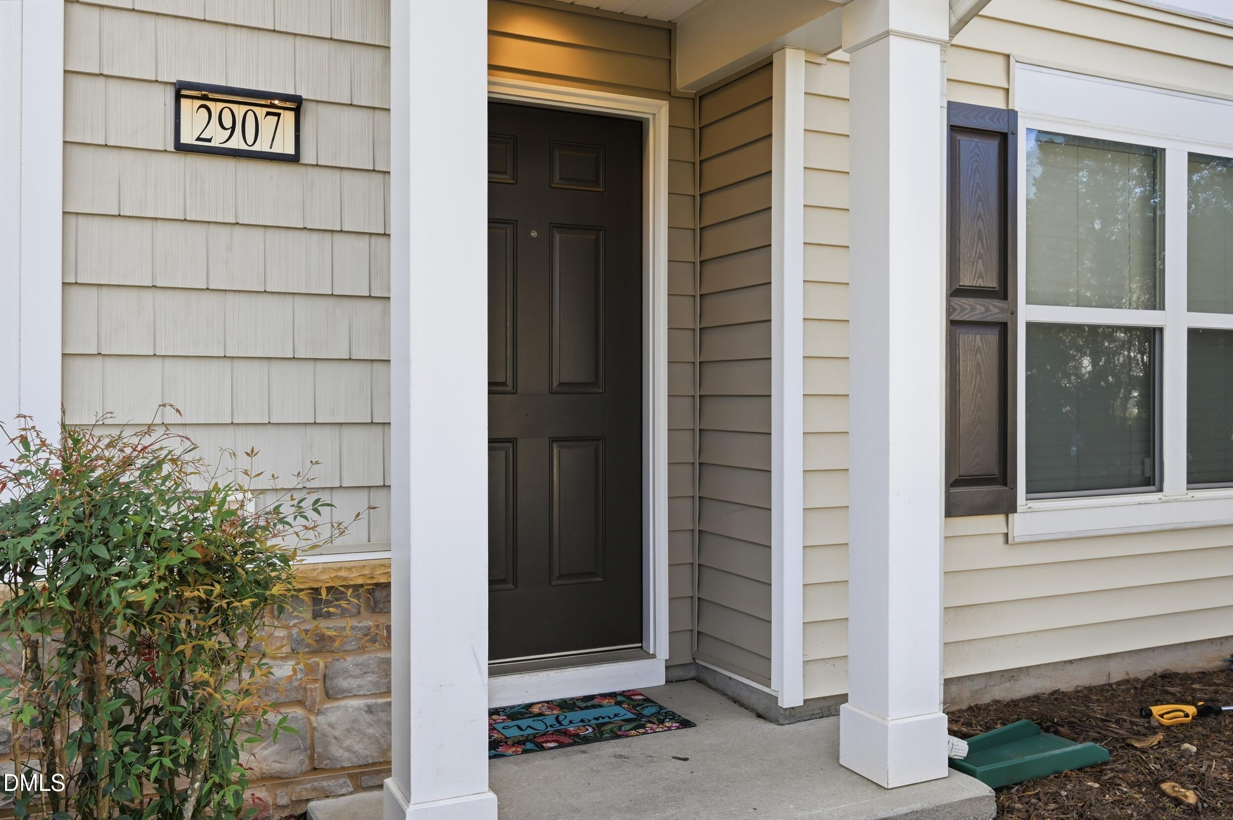 2907 Berkeley Springs Place Raleigh, NC 27616 - Photo 2 of 32 a view of a wooden door of the house