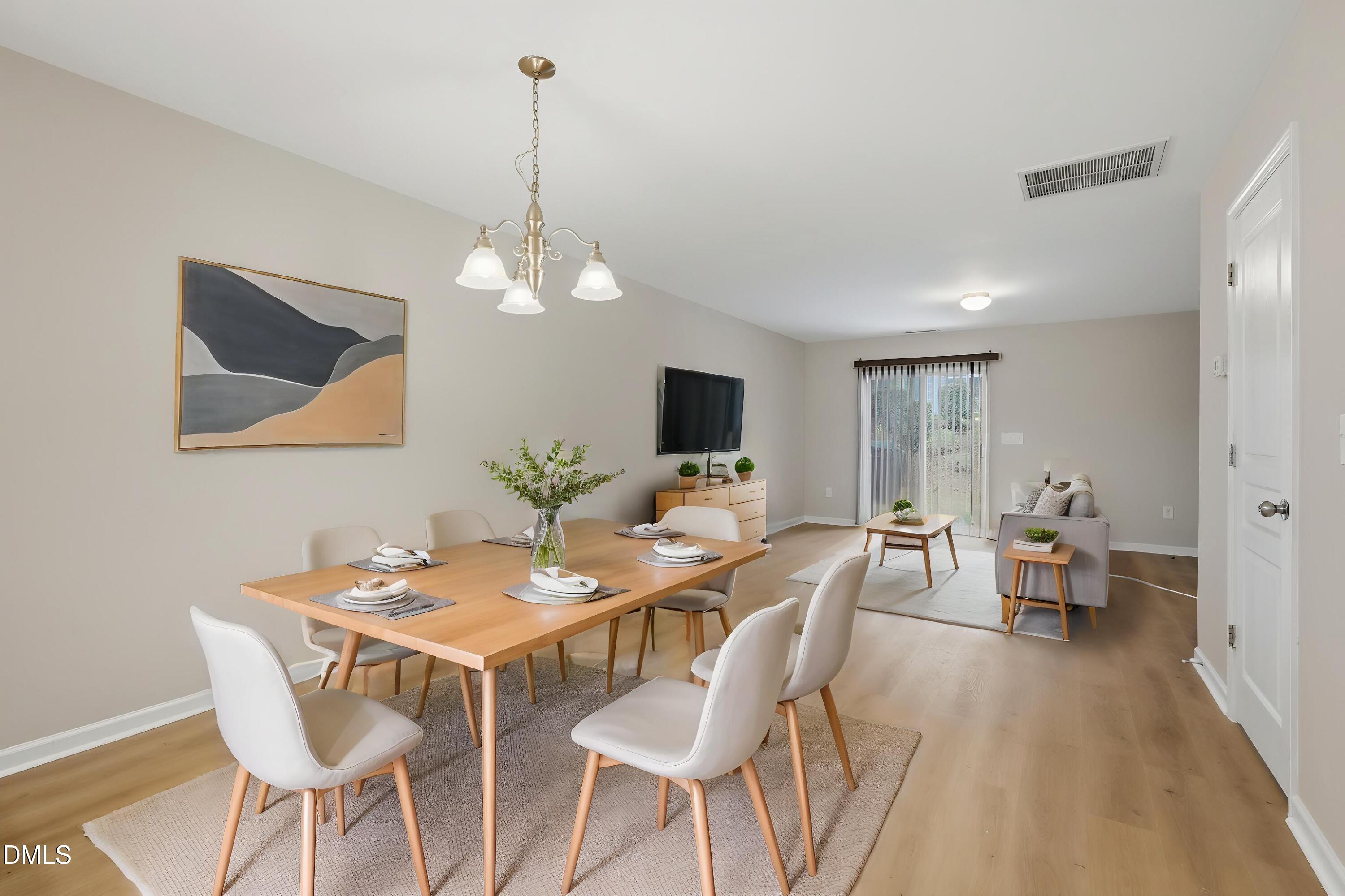 2907 Berkeley Springs Place Raleigh, NC 27616 - Photo 3 of 32 a view of a dining room with furniture and wooden floor